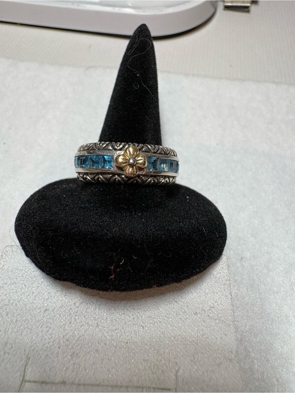 Sterling Silver Blue Topaz Channel Eternity Ring with Gold Flower Accent